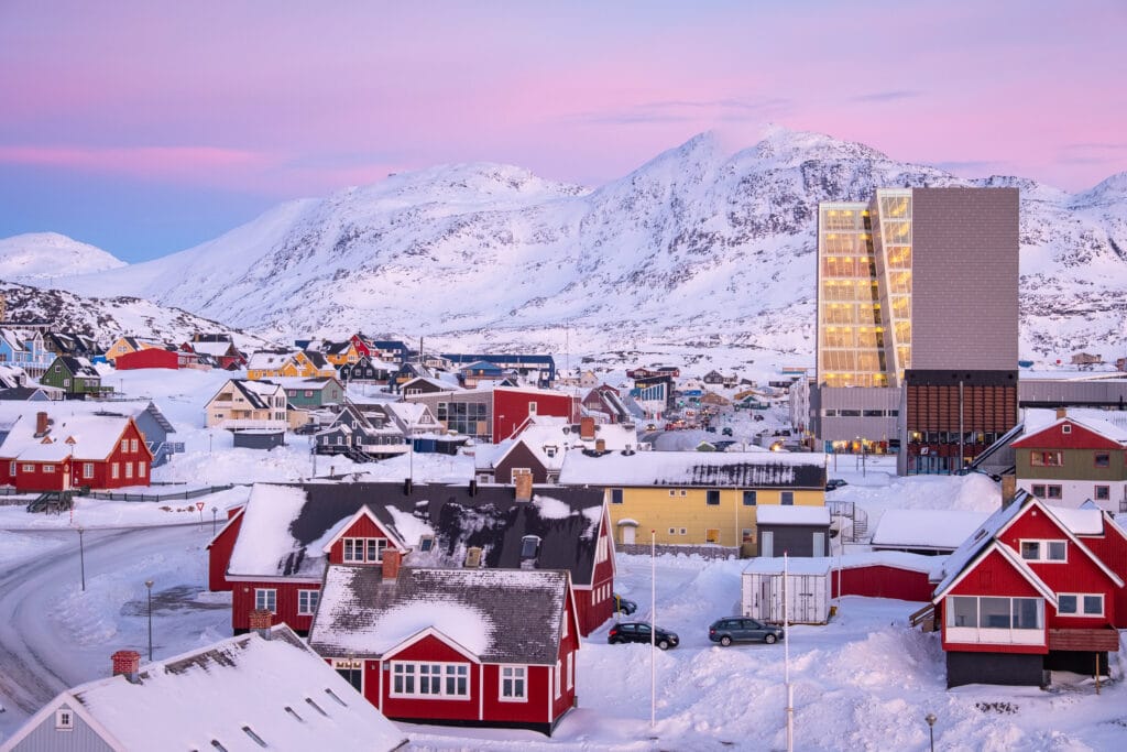 The center of Nuuk, Greenland - taken on a city tour at dusk. Pink skies and the mountain - Store Malene - in the background - Guide to Greenland