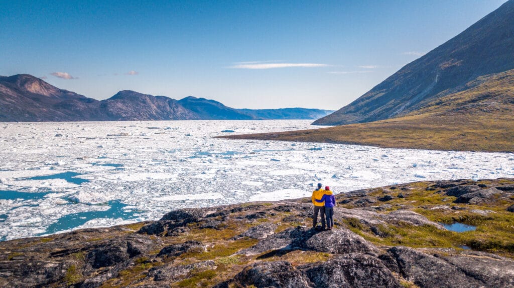 Hikers taking a break to admire the ice in the Nuuk Icefjord - Greenland