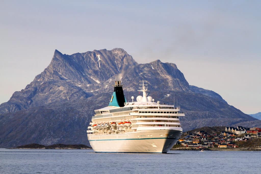 A cruise ship arriving in Nuuk with Sermitsiaq mountain in the background - Greenland