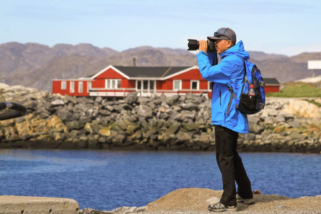 Person taking a photo from the Colonial Harbour in Nuuk - Greenland