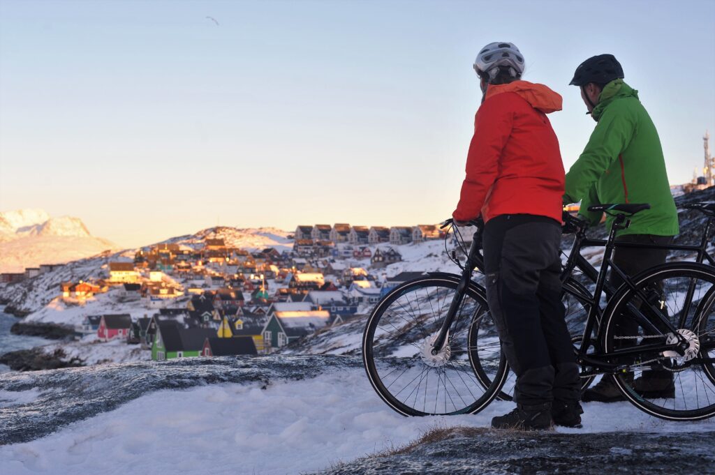 Two people with bikes looking at the view over the Mosquito Valley in Nuuk and Sermitsiaq Mountain - Greenland