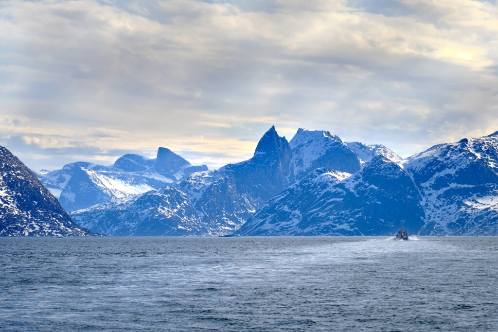 Following another boat into the Nuuk fjord on a boat tour with Guide to Greenland