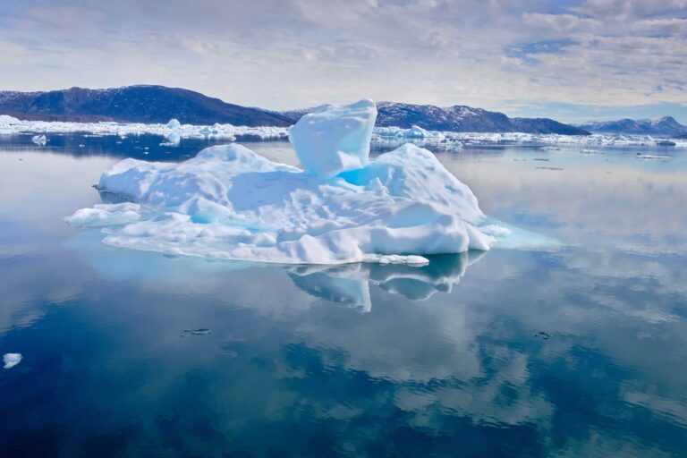 Iceberg reflected and visible beneath the water the Nuuk Icefjord on a boat tour with Guide to Greenland