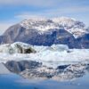 Mountain at the entrance to the Nuuk Icefjord and icebergs reflected in the water on a boat tour with Guide to Greenland
