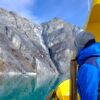 Passenger watches as we approach the mountain at the entrance to the Nuuk Icefjord on a boat tour with Guide to Greenland
