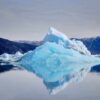Pyramid iceberg reflected in the water the Nuuk Icefjord on a boat tour with Guide to Greenland