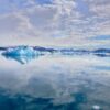 Sky and iceberg reflected in the water the Nuuk Icefjord on a boat tour with Guide to Greenland