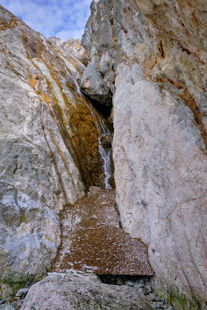 Waterfall falling from the mountain at entrance to the Nuuk Icefjord on a boat tour with Guide to Greenland