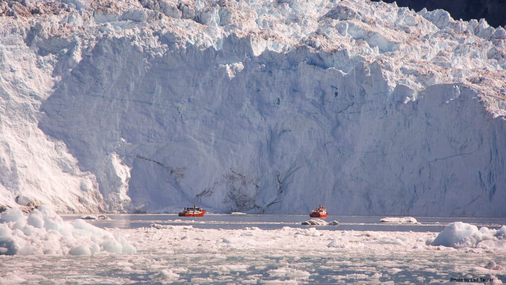 Tour boats in front of the enormous Eqi Glacier near Ilulissat