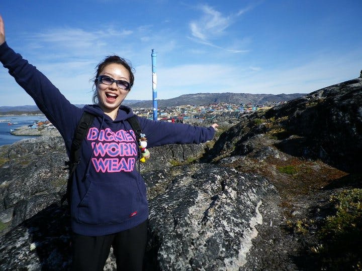 Woman posing on top of a mountain