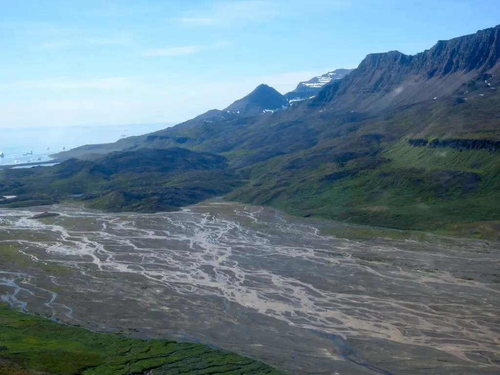 Overlooking a wet area at disko island with mountains in the background