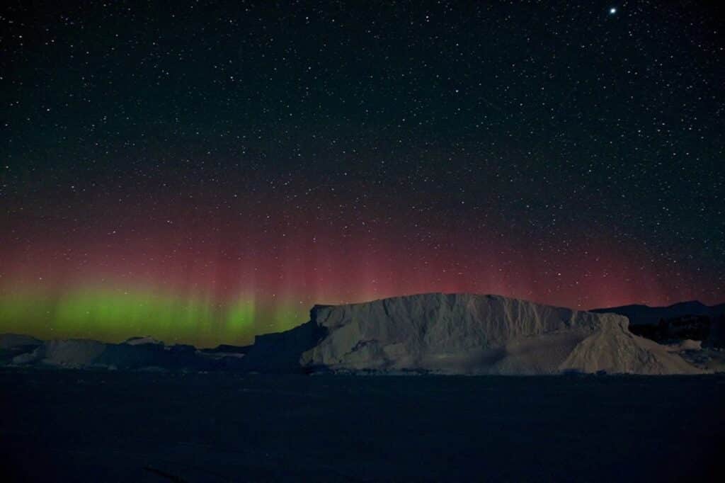 Northern lights pictured over enormous iceberg