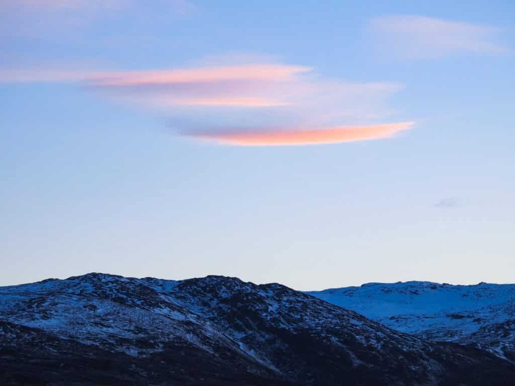 Pink clouds over a mountain