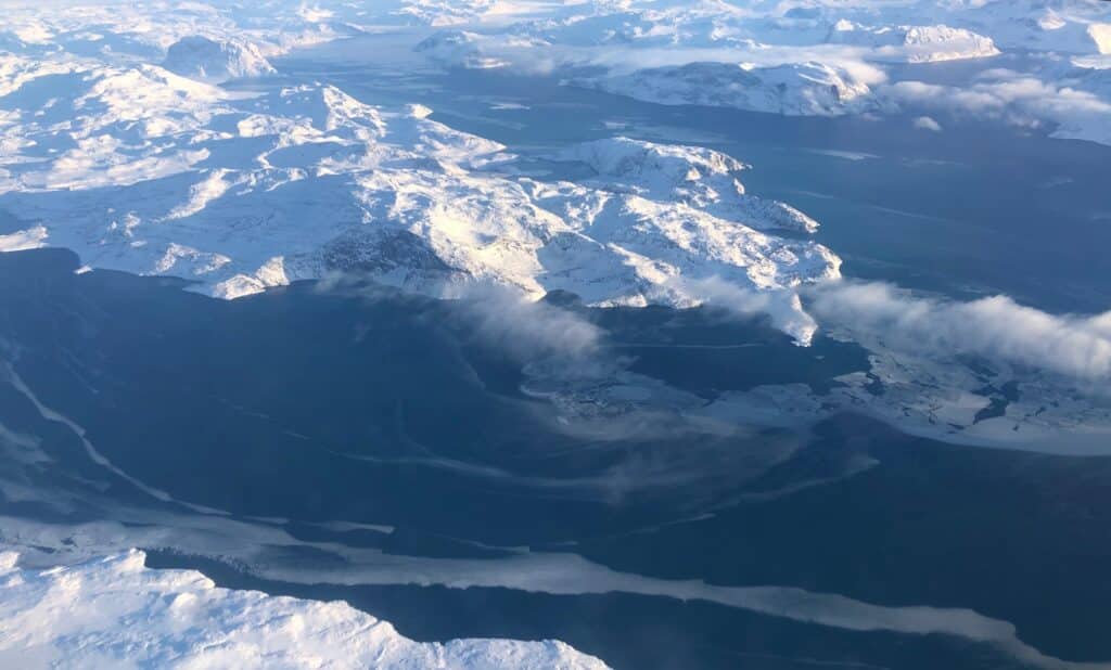 View of Greenland from above, land covered in snow
