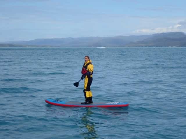 Girl paddleboarding on the icefjord