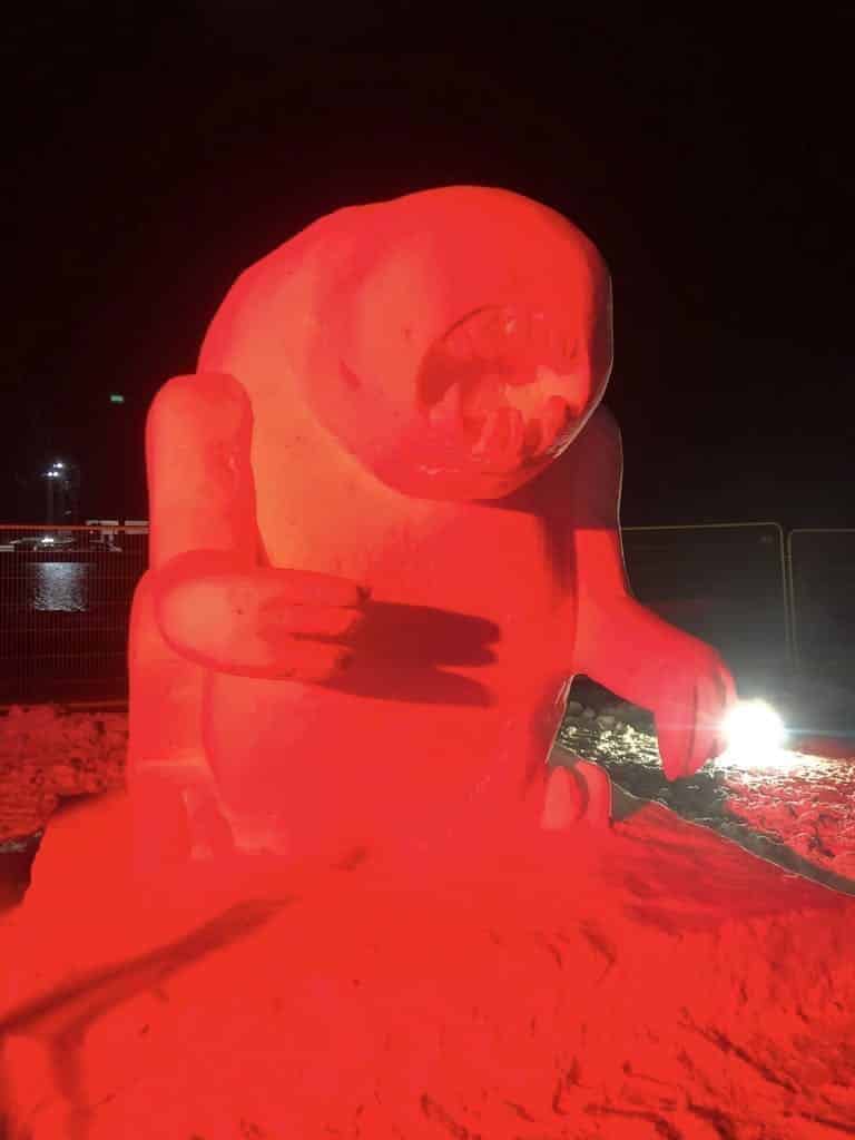 Snow sculpture lit in red