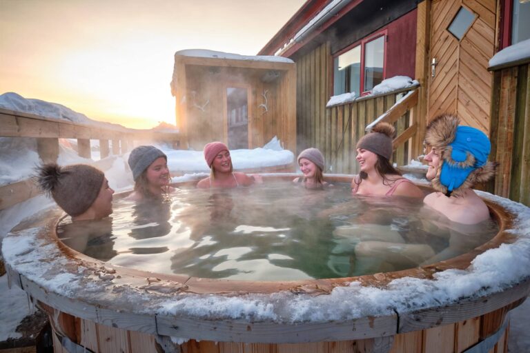 Friends enjoying a wilderness bath spa at the Arctic spa at the hotel sisimiut