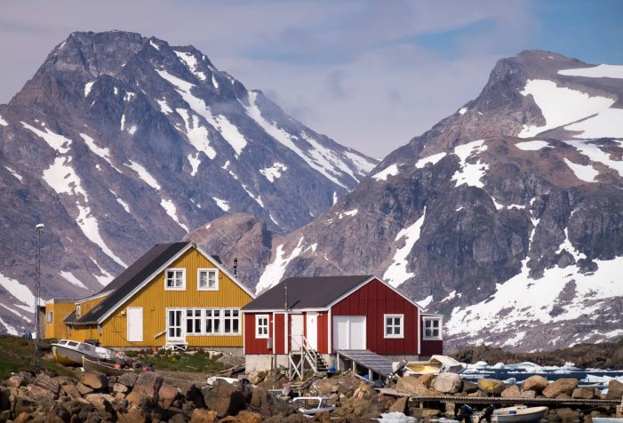 Colorful-houses-in-Kulusuk-set-against-the-impressive-mountains-of-East-Greenland-summer-Guide-to-Greenland Colorful-houses-in-Kulusuk-set-against-the-impressive-mountains-of-East-Greenland-summer-Guide-to-Greenland