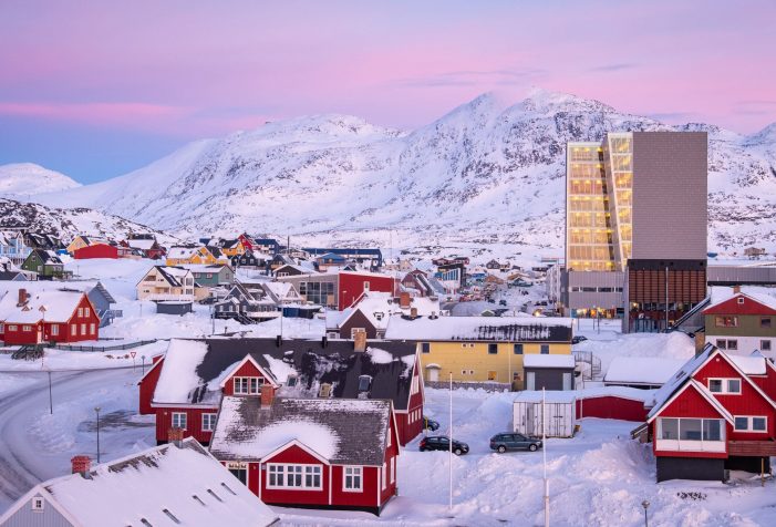 Downtown-nuuk-at-dusk-with-store-malene-in-the-background-Guide-to-Greenland Downtown Nuuk at sunset with pink skies and the mountain - Store Malene - in the background
