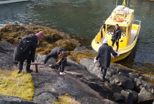 Girls-climbing-rocks-to-boat-Guide-to-Greenland Girls-climbing-rocks-to-boat-Guide-to-Greenland