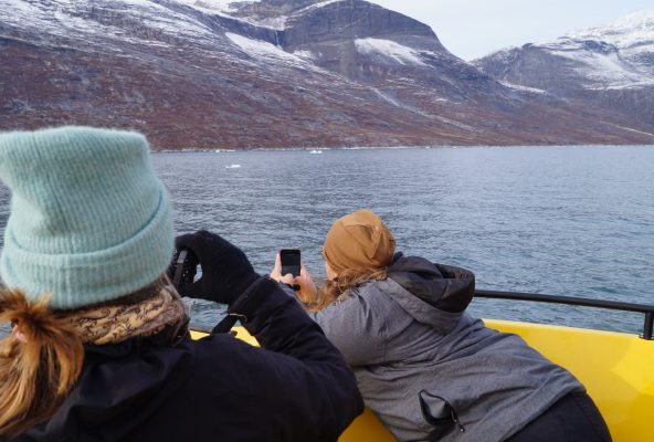 Two-women-taking-pictures-of-whale-from-boat-Guide-to-Greenoland Two-women-taking-pictures-of-whale-from-boat-Guide-to-Greenoland