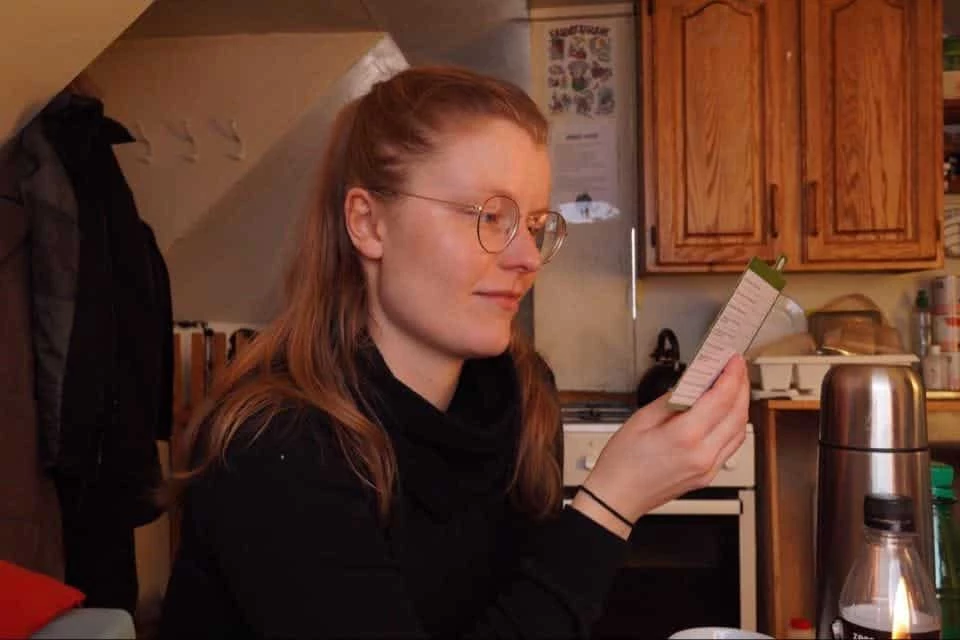 A woman reading something from a board game