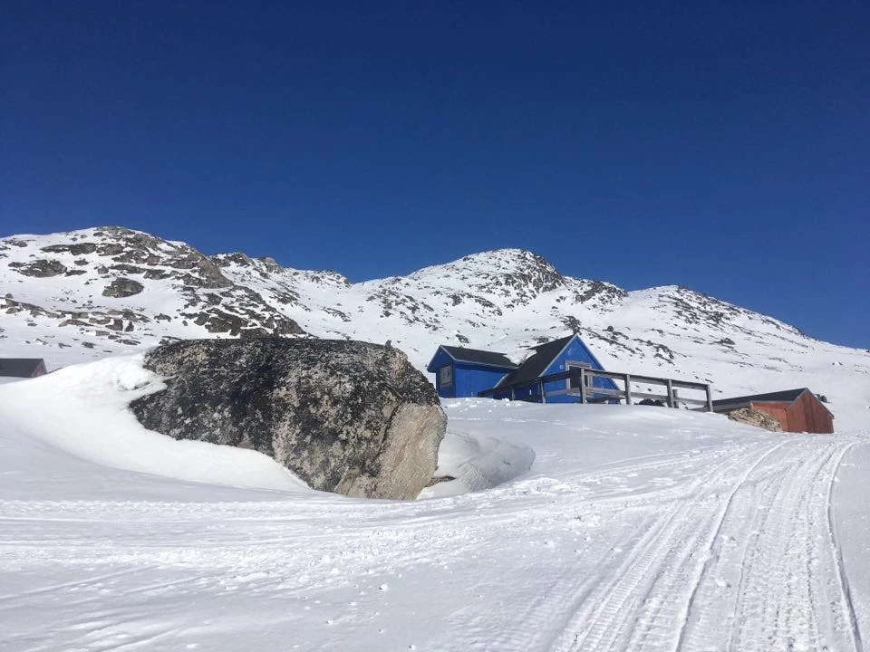 Blue hut surrounded by snow