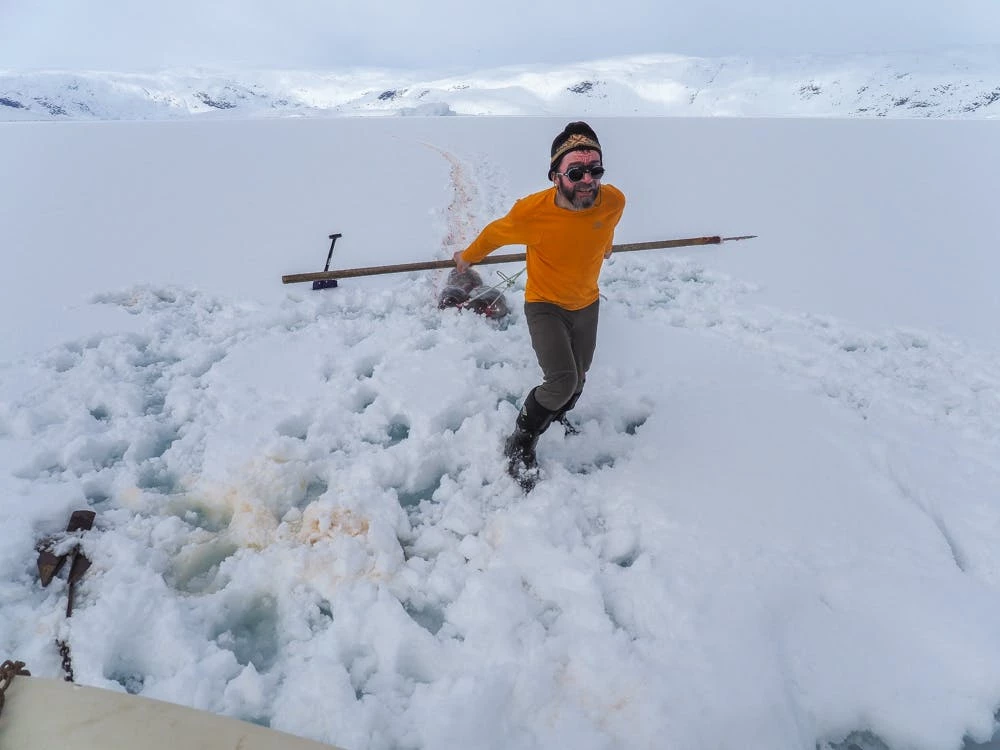 Man carrying two dead seals