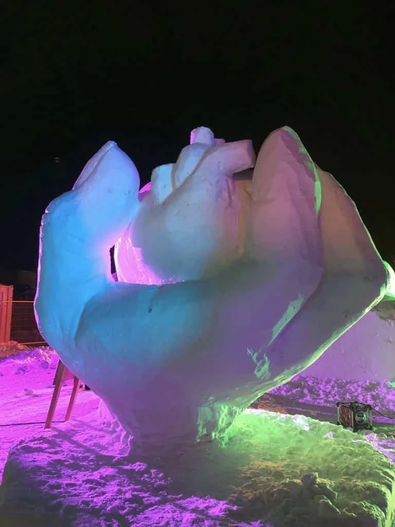 Snow sculpture lit in blue, green and purple
