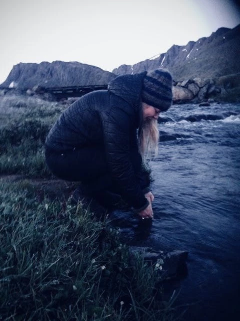 Woman dipping her hands in the water