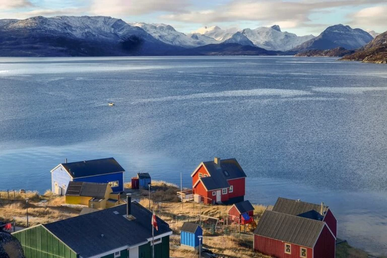View over the colorful houses of Kapisillit looking out into the fjord - summer - Guide to Greenland